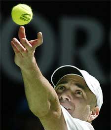 Andre Agassi of the USA serves to Sebastien Grosjean of France during their quarterfinal match at the Australian Open