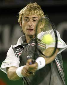 Juan Carlos Ferrero of Spain hits a backhand