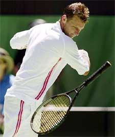 David Nalbandian of Argentina throws his racket after losing a point to Rainer Schuettler of Germany in their quarterfinal match at the Australian Open