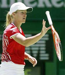 Justine Henin-Hardenne of Belgium tosses her racket after a missed point
