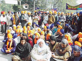 Members of the Khalsa Panchayat sit outside Mini Secretariat to present a memorandum to the DC to protest against the capital punishment awarded