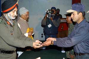 An ULFA militant lays down arms during a surrender ceremony at Rangia, near Guwahati