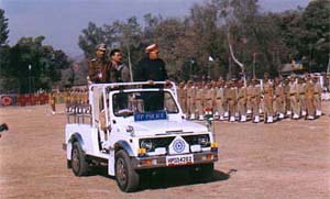 Chief Minister Prem Kumar Dhumal inspects the parade at a Full Statehood Day function