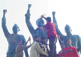 Members of the Shiv Sena pour milk on the statues of martyrs on the eve of Republic Day in Ludhiana on Saturday.