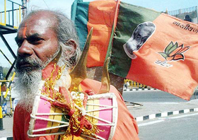 A sadhu carrying the BJP flag 