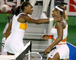 Venus Williams of the US congratulates her sister Serena after the women's final at the Australian Open 