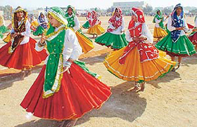 Schoolgirls present a Haryanvi dance during the 54th Republic Day celebrations