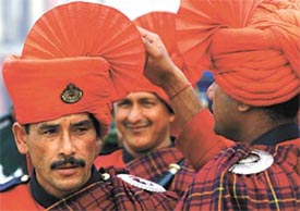 A member of an Indian Army Band assists his colleague in tying his turban during the rehearsal for 'Beating the Retreat