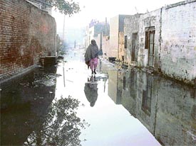 Sullage overflowing from drains and houses adds to the misery of residents