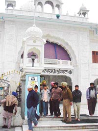 Police personnel come out of a gurdwara in Ludhiana where a theft of over Rs 1 lakh was reported