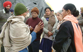 Ms Laxmi Kanta Chawla, a former MLA, makes inquiries at Thathi village regarding the bashing up of the ASI.