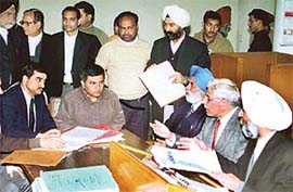Mr Justice N.K. Sodhi, Judge Punjab and Haryana Court, Mr H.S. Bhalla, UT District and Sessions Judge, and Mr J.S. Kler, UT Additional District and Sessions Judge, during a special Lok Adalat held on the District Courts premises in Chandigarh