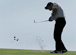 Paul Casey of England plays an approach shot towards the 16th green