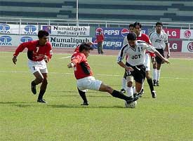 JCT Phagwara striker Hardip Gill being checked by a Mahindra United defender 