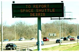 A sign along a road in Dallas, Texas, asks the public to call in locations of space shuttle debris 