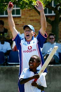 England's captain Nasser Hussain celebrates after taking the wicket of a student from the Sidman School in Port Elizabeth 
