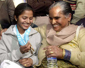 Sunita Rani shows her medals to her mother