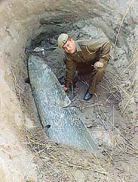 A policeman inspects a metal piece believed to be the wing of an aircraft in the Markanda riverbed near Rola Heri village, Ambala, on Wednesday.