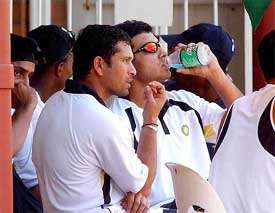 Indian cricketers, Harbhajan Singh, Sachin Tendulkar and Saurav Ganguly watch from the side line during their warm-up match