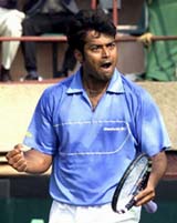 Tennis star Leander Paes reacts after making a point against Takao Suzuki 