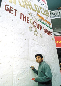 Ajay Jadeja signs a giant card wishing the Indian team at B Block in Connaught Place.