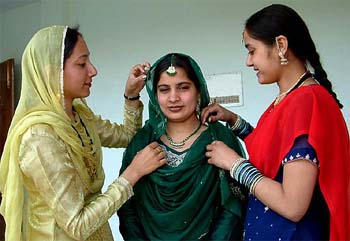 The students of SSD Girls College help each other in make-up