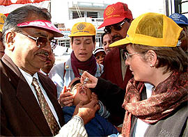 Members of a team from France administer polio drops to a child