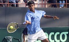 India's Rohan Boppana returns a forehand 