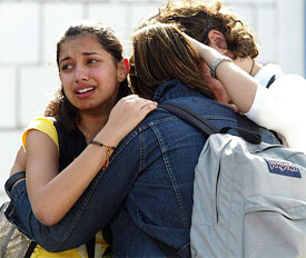 Students embrace while saying goodbye as American International School closes in Kuwait City on Sunday for an extended break of 6 weeks 