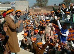 Shiromani Akali Dal President Parkash Singh Badal and General Secretary Sukhbir Singh Badal lead workers as they jam traffic on the Bathinda-Abohar state highway