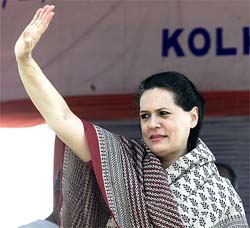 Congress President Sonia Gandhi waves to the crowd during a rally