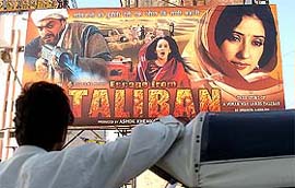 A man looks up at an advertisement billboard