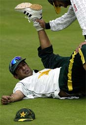 Wasim Akram stretches during a training session 