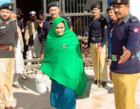 An Afghani woman prisoner leaves the central jail
