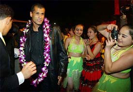 A Chinese fan takes a picture of Brazilian forward Rivaldo as he arrives at a hotel in Guangzhou