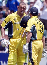 Australian batsman Andy Symonds talks to Ian Harvey after scoring a century