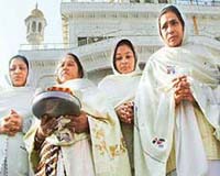 Women who were widowed during the 1984 riots stage a dharna in front of Akal Takht on Wednesday.