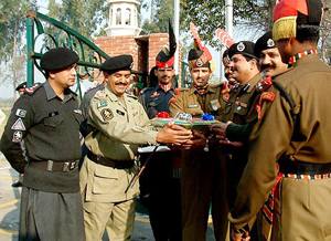 Mr Mohammed Sharief, second-in-command of the Pakistan Rangers, presents a basket of sweets