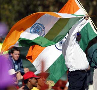 Indian cricket fans wave their national flag during their team's first match of the ICC cricket World Cup against Holland 