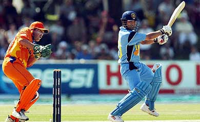 India's Sachin Tendulkar hits a shot as Dutch wicketkeeper Jeroen Smits reacts 