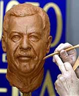 A sculptor gives final touches to a clay mould of Iraqi President Saddam Hussein 