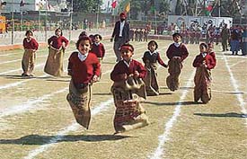 Students of the Shishu Vatika branch of BVM School take part in a sack race during the annual athletics meet