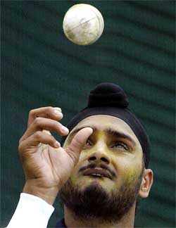 India's Harbhajan Singh throws the ball in the air