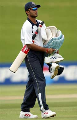 Indian captain Saurav Ganguly carries his batting gear 