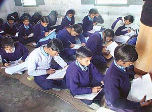 Students of class VIII sit on the floor and take their examination in Ludhiana