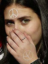 Anti-war protester covers her mouth