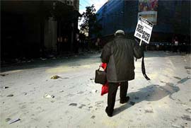 A protester walks on a major street of Athens