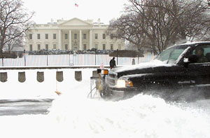 A snow plough clears the Pennsylvania Avenue in front of the White House in Washington