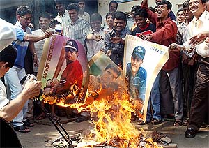 Cricket fans burn large posters of Indian cricketers on the streets of Mumbai 