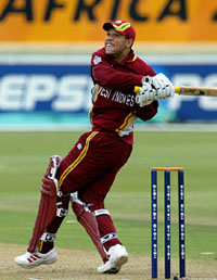 Ricardo Powell of West Indies watches as he hits a six 